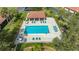 Overhead image of a community pool area featuring lounge seating, greenery, and shade at 7269 Golf Pointe Way, Sarasota, FL 34243