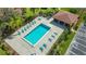 Overhead shot of a sparkling community pool with lounge chairs and verdant landscaping at 7269 Golf Pointe Way, Sarasota, FL 34243