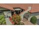 Home's private courtyard with tiled patio, seating, and lush landscaping at 7269 Golf Pointe Way, Sarasota, FL 34243