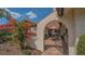 View of the tiled front courtyard with outdoor seating through the gated archway at 7269 Golf Pointe Way, Sarasota, FL 34243