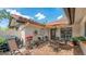 Brick paved courtyard with outdoor furniture, grill, and view of the front entrance at 7269 Golf Pointe Way, Sarasota, FL 34243