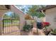 Landscaped front courtyard showing a lounge chair and blooming bougainvillea at 7269 Golf Pointe Way, Sarasota, FL 34243