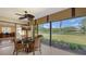 Dining area with an outside view, modern ceiling fan, and a table with seating at 7269 Golf Pointe Way, Sarasota, FL 34243