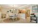 The dining area adjacent to the kitchen includes a stylish chandelier and seating for four at 7269 Golf Pointe Way, Sarasota, FL 34243