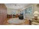 The home office features built-in cabinets, lots of light, and a comfortable chair at 7269 Golf Pointe Way, Sarasota, FL 34243