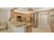 The kitchen features stainless steel appliances, granite countertops, and ample cabinet space at 7269 Golf Pointe Way, Sarasota, FL 34243