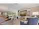 Inviting living room with comfortable seating, built-in shelving, and views of the outdoor patio at 7269 Golf Pointe Way, Sarasota, FL 34243