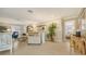 Bright living room features tile flooring, neutral walls, and a view into an adjacent bedroom at 7269 Golf Pointe Way, Sarasota, FL 34243
