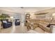 Comfortable living room with a tan sectional, tile floors, and stylish decor at 7269 Golf Pointe Way, Sarasota, FL 34243