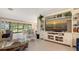 Comfortable living room with tile flooring, custom built-ins, and a glass coffee table at 7269 Golf Pointe Way, Sarasota, FL 34243