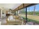 Living room featuring great outdoor views and a comfortable seating area at 7269 Golf Pointe Way, Sarasota, FL 34243