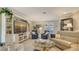 Comfortable living room features built-in shelving and large windows for abundant natural light at 7269 Golf Pointe Way, Sarasota, FL 34243
