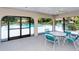 Poolside pavilion featuring a cozy seating area, perfect for gatherings and relaxation overlooking the pool at 7269 Golf Pointe Way, Sarasota, FL 34243