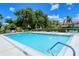 Enjoy a refreshing dip in the community pool, surrounded by lush landscaping and comfortable seating at 7269 Golf Pointe Way, Sarasota, FL 34243
