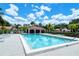 Inviting community pool with a covered pavilion, offering a refreshing escape in a tropical setting at 7269 Golf Pointe Way, Sarasota, FL 34243