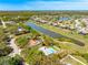 Property aerial view showcases a backyard pool, lake views, and a green landscape at 7299 S Leewynn Dr, Sarasota, FL 34240