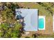 Overhead view of the property showcasing a well-maintained roof and backyard pool, surrounded by lush greenery at 7299 S Leewynn Dr, Sarasota, FL 34240