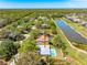 Aerial view of property with a pool, a large backyard, and proximity to a serene lake at 7299 S Leewynn Dr, Sarasota, FL 34240