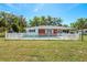 Backyard view of a home featuring a well-maintained lawn and a fenced-in pool, perfect for relaxation and entertainment at 7299 S Leewynn Dr, Sarasota, FL 34240