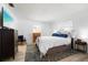 Bright bedroom with minimalist decor, plush bedding, and wood-look flooring at 7299 S Leewynn Dr, Sarasota, FL 34240