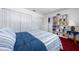 Bedroom features a red carpet, built-in bookcase, closet, and a large bed with a blue and white comforter at 7299 S Leewynn Dr, Sarasota, FL 34240