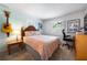 Comfortable bedroom featuring light walls, a patterned bedspread, and natural lighting at 7299 S Leewynn Dr, Sarasota, FL 34240