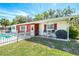Charming home featuring an inviting outdoor seating area and a fenced in pool for leisure and relaxation at 7299 S Leewynn Dr, Sarasota, FL 34240