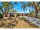 Inviting single-Gathering home with a long driveway and mature trees, offering shade and curb appeal at 7299 S Leewynn Dr, Sarasota, FL 34240