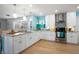 Bright kitchen with stainless steel appliances, white cabinets, and a stylish backsplash at 7299 S Leewynn Dr, Sarasota, FL 34240