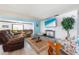 Comfortable living room with a large TV, stylish furnishings, and a calming color scheme for a relaxed ambiance at 7299 S Leewynn Dr, Sarasota, FL 34240