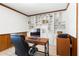 Bright home office with built in bookshelves and a large executive chair at 7299 S Leewynn Dr, Sarasota, FL 34240