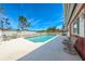 Backyard view of the pool, with a white fence, and lounge chairs, great for outdoor living and entertaining at 7299 S Leewynn Dr, Sarasota, FL 34240