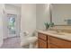 Bathroom with light brown wooden cabinetry and a door leading to the backyard pool at 7407 Green St, Bradenton, FL 34201