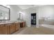 Spacious bathroom with double vanity, soaking tub, and walk-in closet, providing ample space and functionality at 7407 Green St, Bradenton, FL 34201