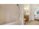 Well-lit bathroom features a shower over tub and a vanity with wood cabinetry at 7407 Green St, Bradenton, FL 34201