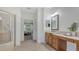 Bright bathroom with a walk-in shower, vanity with lots of storage, and view into the main bedroom at 7407 Green St, Bradenton, FL 34201