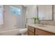 Bathroom features tiled shower, bathtub, and a vanity with wood cabinetry at 7407 Green St, Bradenton, FL 34201