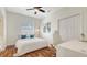 This bedroom features wood floors, a ceiling fan, a large closet and a bright sunny window at 7407 Green St, Bradenton, FL 34201
