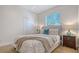 This bedroom features a neutral color scheme and a window bringing in natural light at 7407 Green St, Bradenton, FL 34201