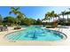 Large community pool featuring clear blue water, plenty of seating, and lush tropical landscaping at 7407 Green St, Bradenton, FL 34201