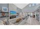 Bright living room with a soaring ceiling and a stone fireplace that adds texture and warmth to the space at 7407 Green St, Bradenton, FL 34201