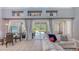Cozy living area with large windows leading to the patio, an adjacent dining area and comfortable seating at 7407 Green St, Bradenton, FL 34201