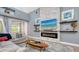 Modern living room with an electric fireplace, TV, and floating shelves at 7407 Green St, Bradenton, FL 34201