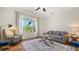 Cozy living room with large windows, letting in lots of light, and comfortable seating for relaxing and entertaining at 7407 Green St, Bradenton, FL 34201