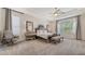 Serene main bedroom with tray ceilings, plush carpet, and a cozy sitting area, creating a luxurious retreat at 7407 Green St, Bradenton, FL 34201