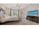 Elegant main bedroom with a large window, TV and access to the pool, offering comfort and convenience at 7407 Green St, Bradenton, FL 34201