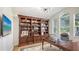 Spacious office featuring custom wood built-ins, decorative lighting and adjacent to an arched window at 7407 Green St, Bradenton, FL 34201