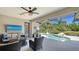 Inviting screened-in lanai with a comfortable seating area overlooking a sparkling pool and lush landscaping at 7407 Green St, Bradenton, FL 34201