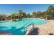 A large community pool with plenty of seating and palm trees at 7407 Green St, Bradenton, FL 34201