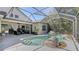 Outdoor screened in pool area with an outdoor living space and tropical landscaping at 7407 Green St, Bradenton, FL 34201
